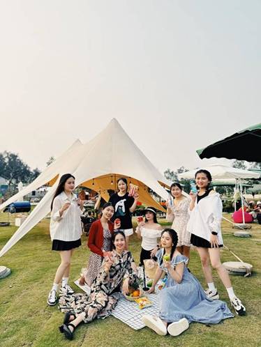 A group of women standing in front of a tent

Description automatically generated