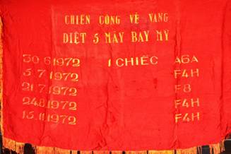 A red banner with gold text

Description automatically generated